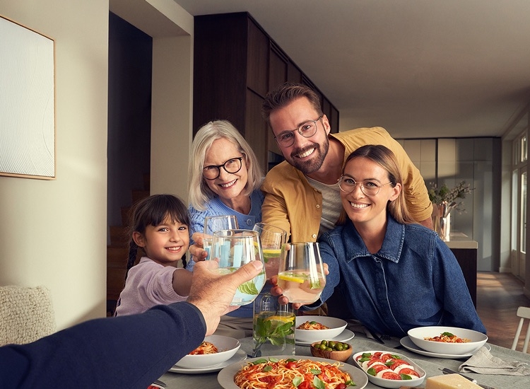 Family sitting at a dinner table enjoying a meal together