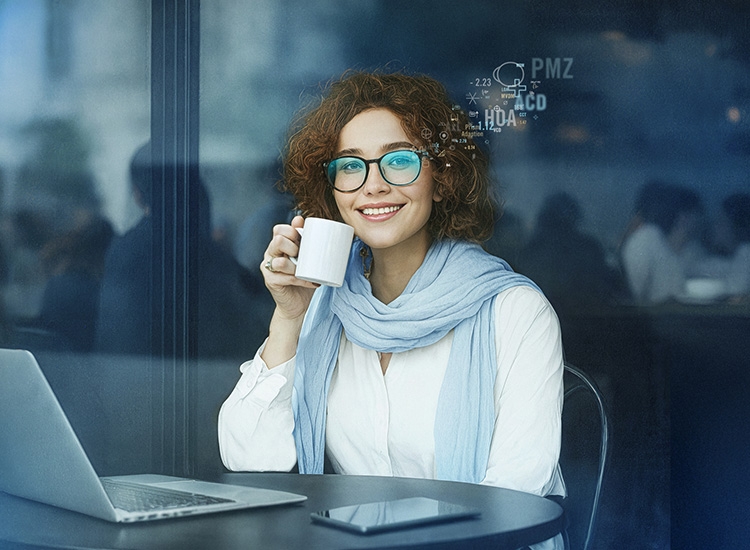 Woman sitting at a laptop searching for a Rodenstock optician nearby